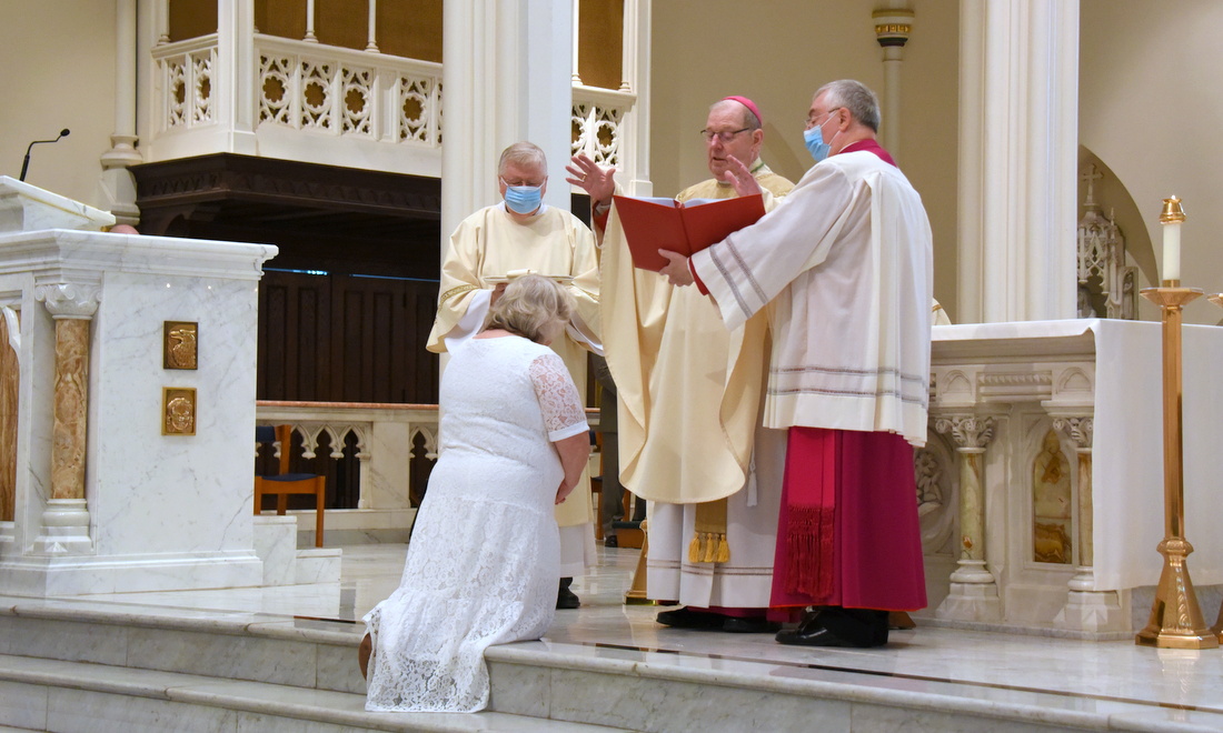 Bishop Robert Deeley prays the Prayer of Consecration for Angela McCormick