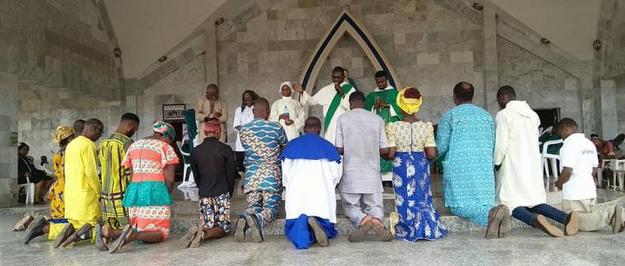 Dominican Fathers and Brothers with indigenous peoples praying