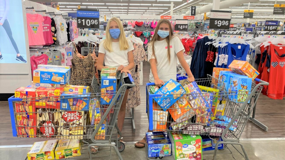 shoppers with carts of food