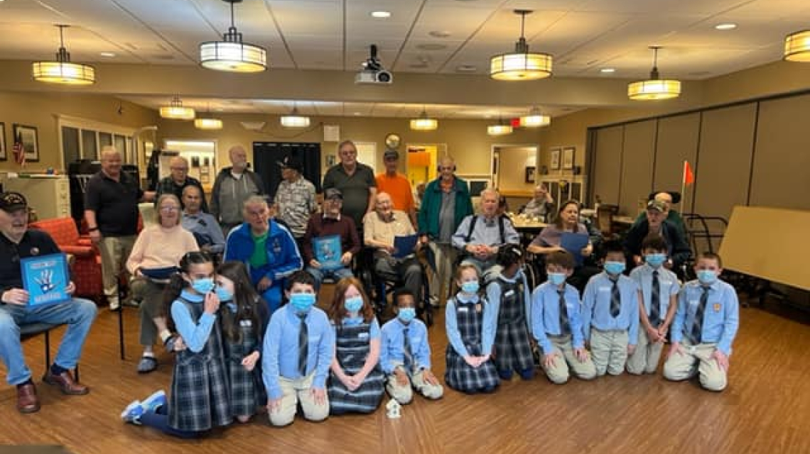 Holy Cross students in South Portland meet their veteran pen pals. 