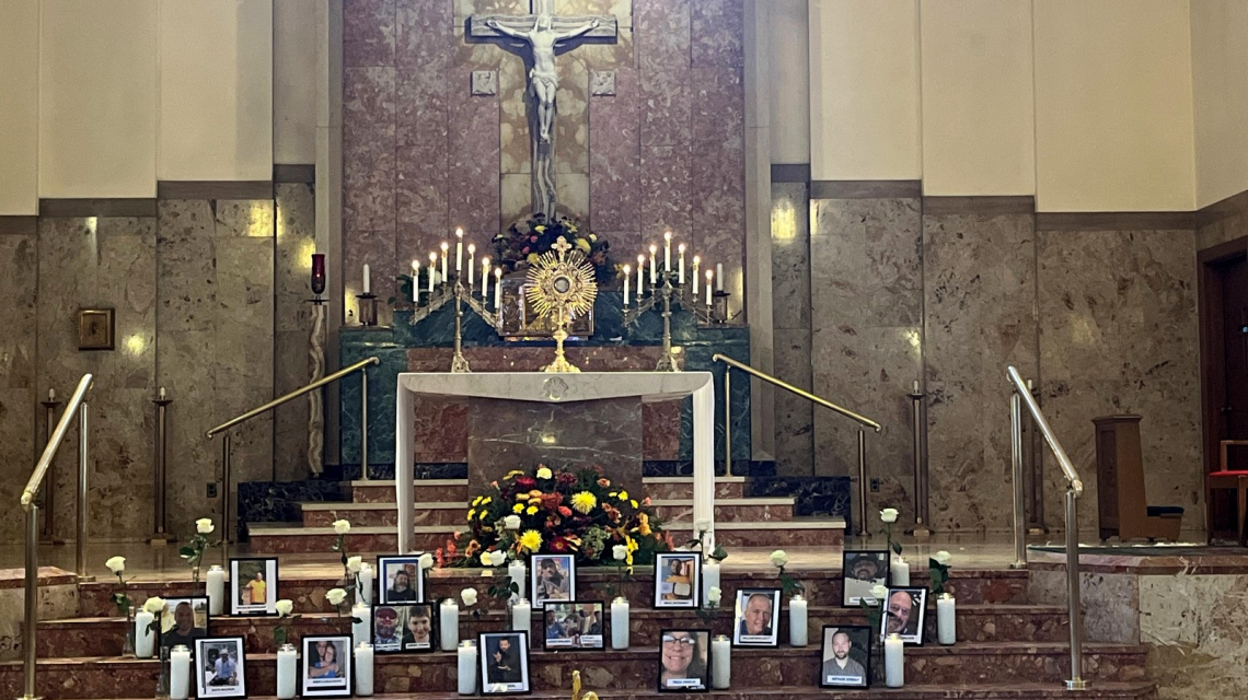 Holy Family Church with photos of shooting victims