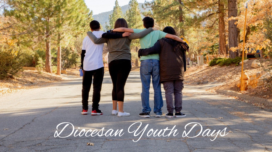 Four teens walking with arms around each other.