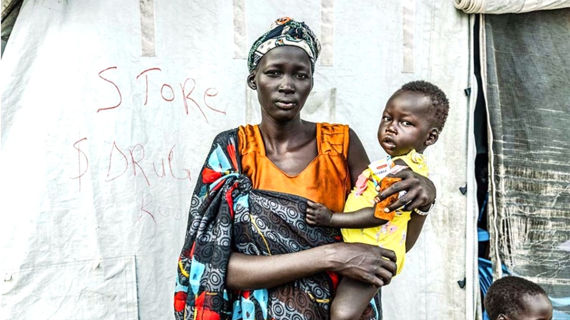 Woman holding a child in South Sudan.