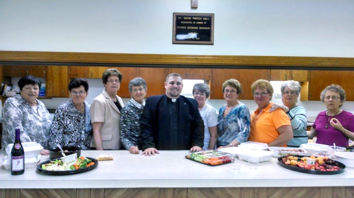 Father Brad Morin with women volunteers