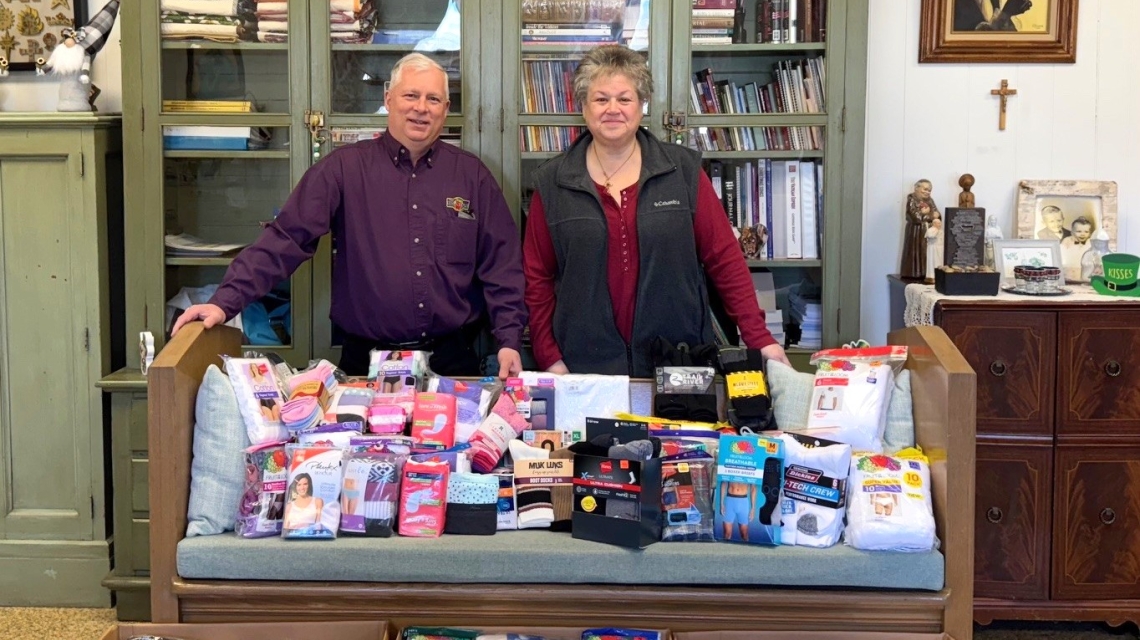 Jail ministry volunteers behind donated items.