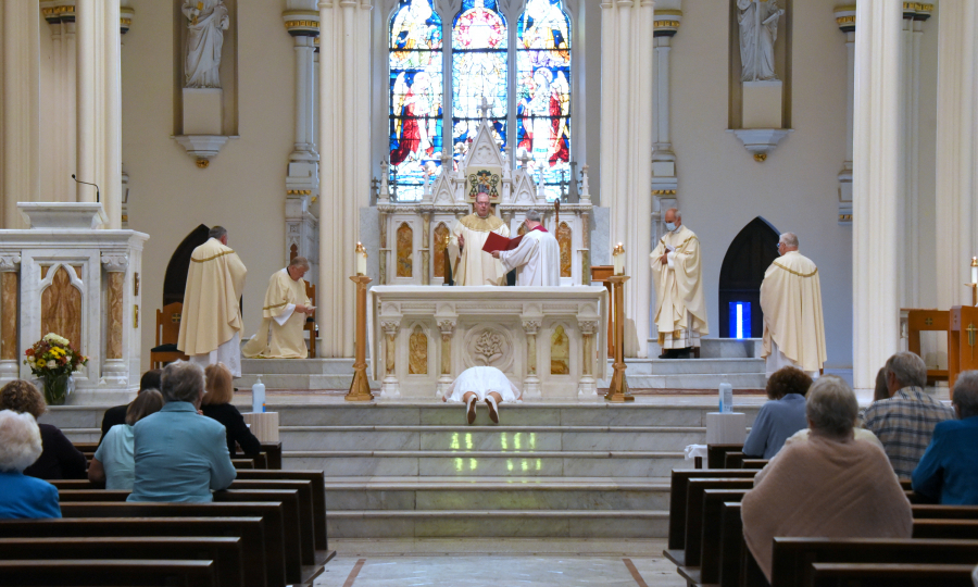 Angela McCormick lies prostrate while the Litany of Saints is sung.
