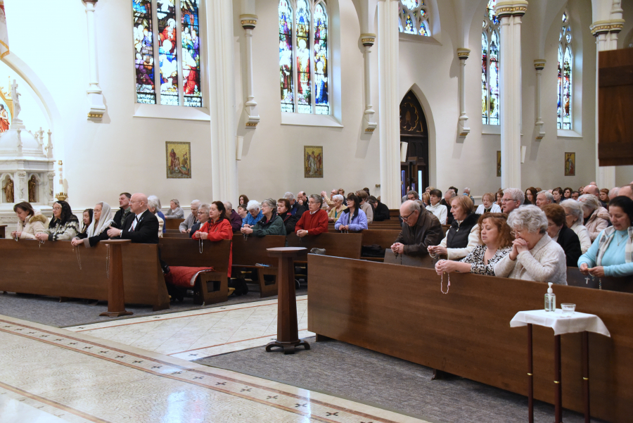 Parishioners join in praying the Rosary.