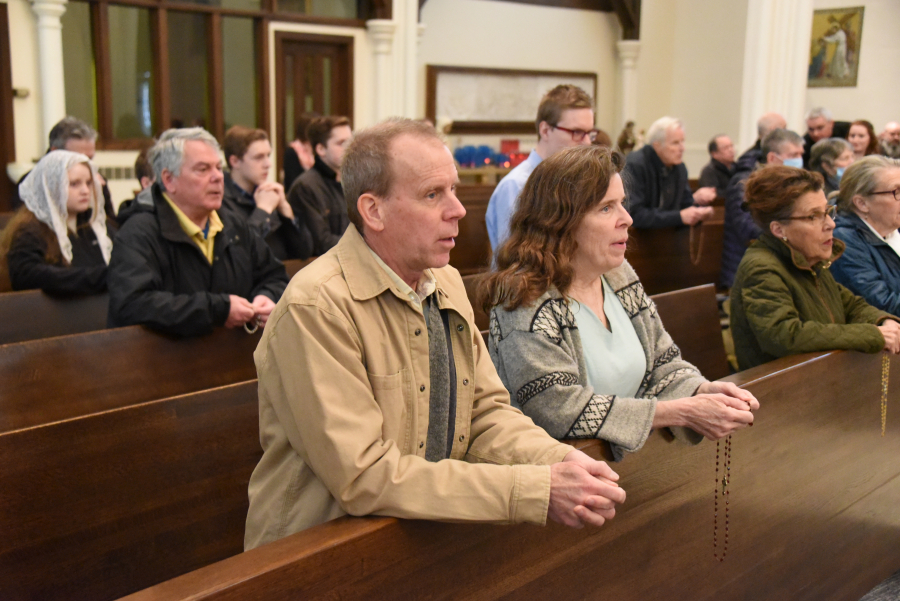 Parishioners Charlie and Claire Fitts join in praying the Rosary.