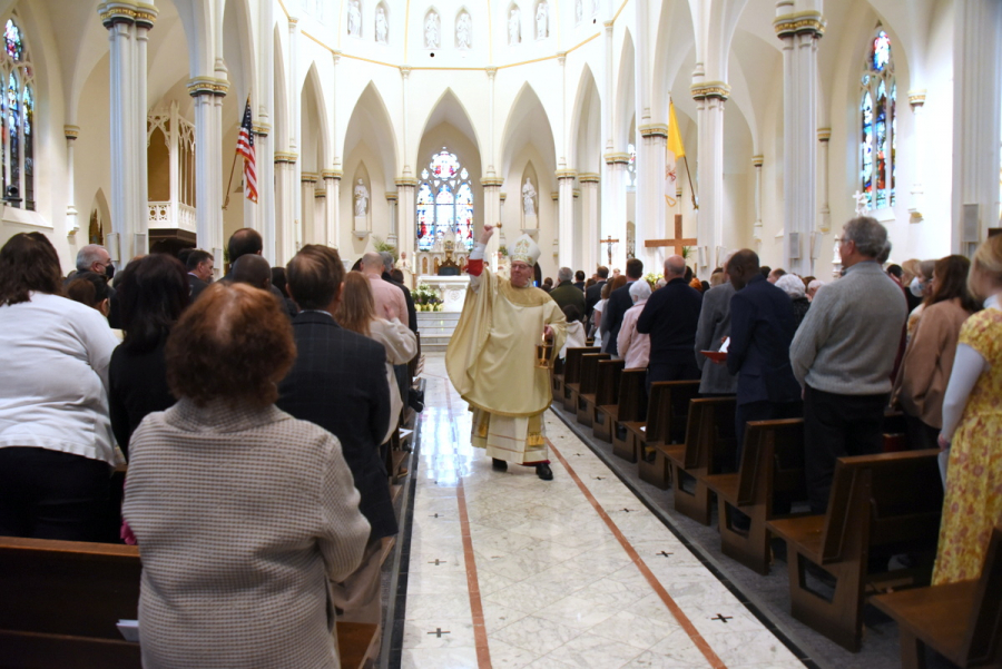 Bishop Robert Deeley sprinkles holy water on the congregation.