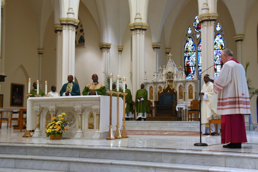 Msgr. Marc Caron greets the cardinal on behalf of Bishop Deeley