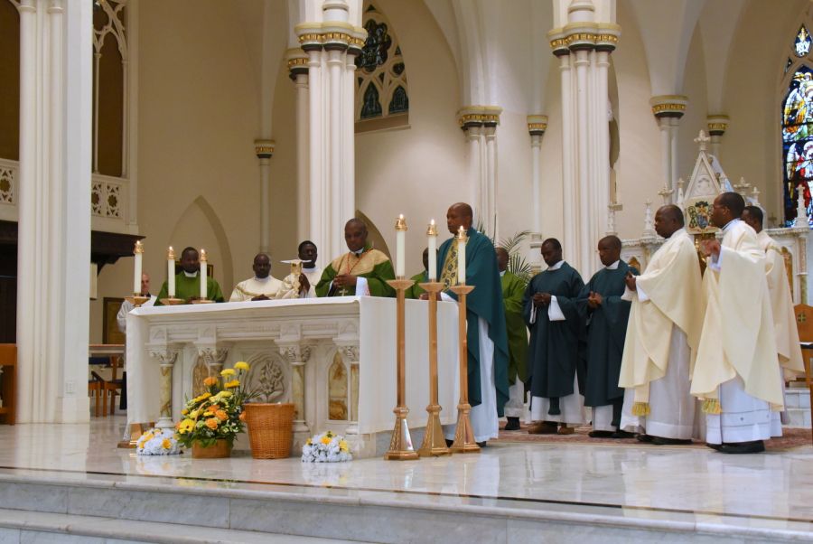 Cardinal and priests in the sanctuary