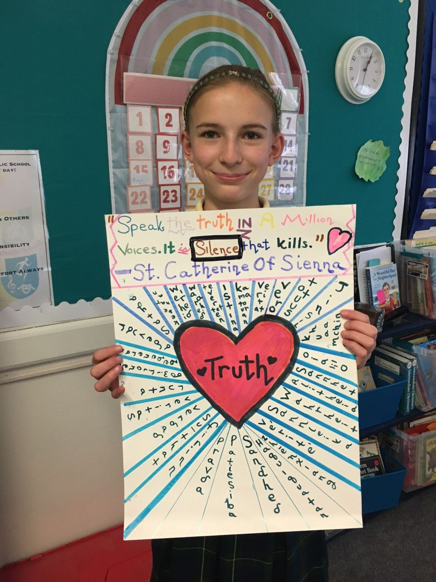 Teen holding up a poster