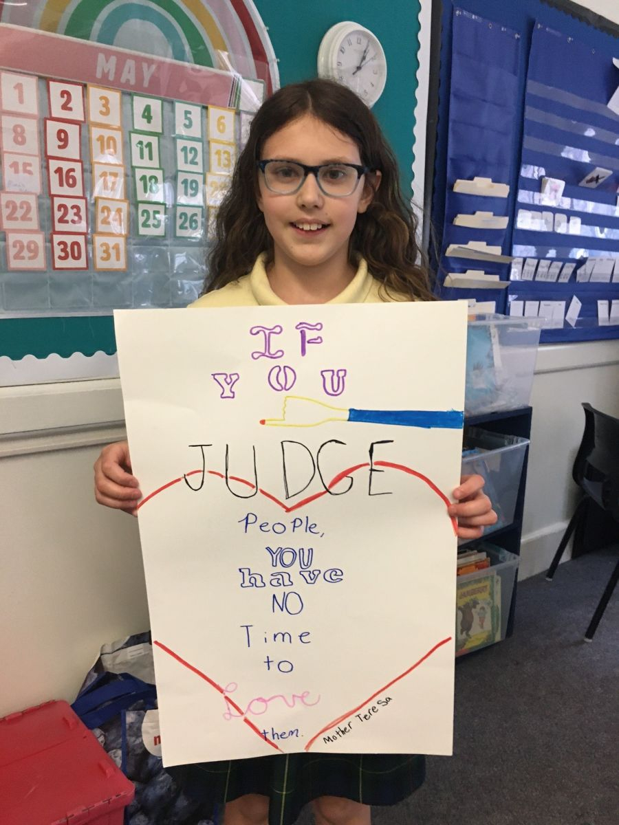 Teen holding up a poster