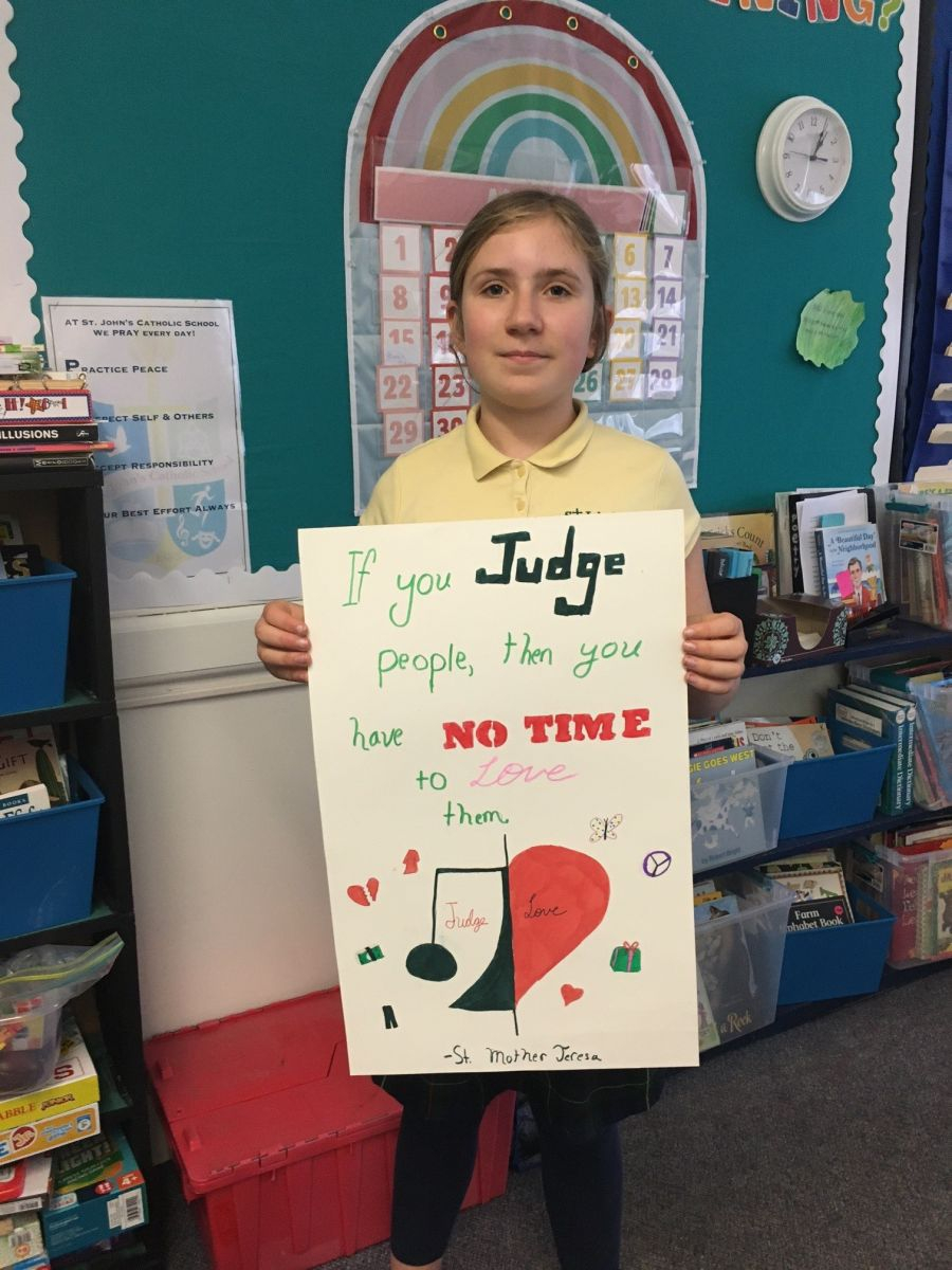 Teen holding up a poster