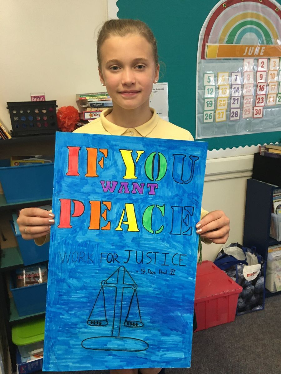 Teen holding up a poster