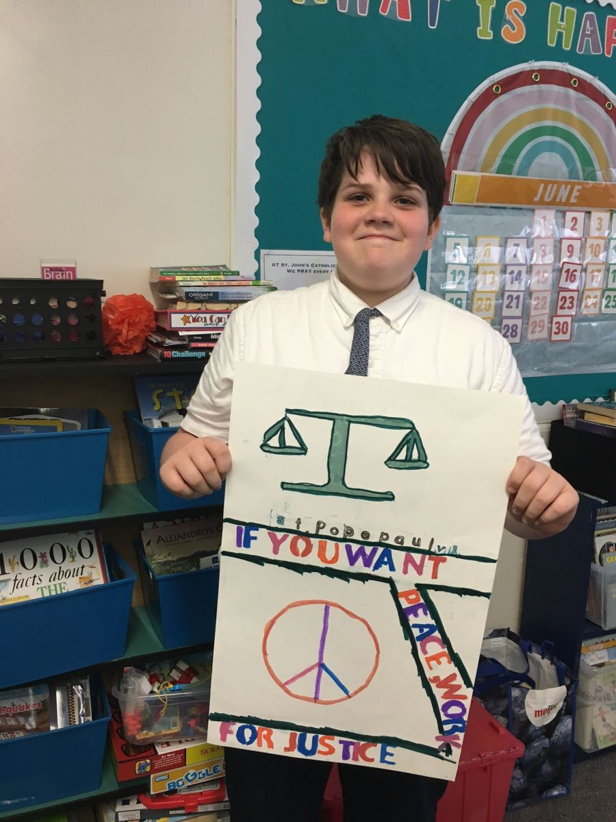 Teen holding up a poster