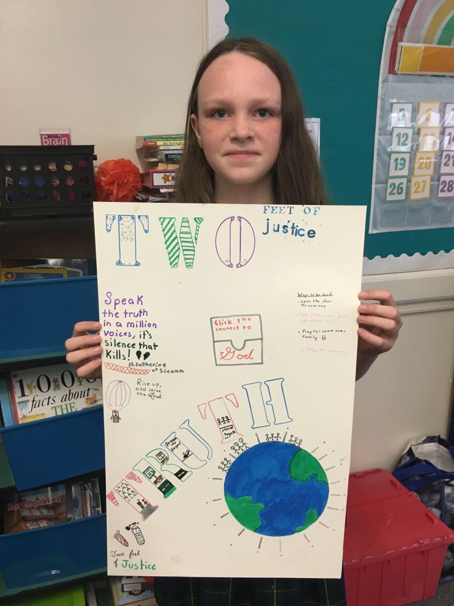 Teen holding up a poster