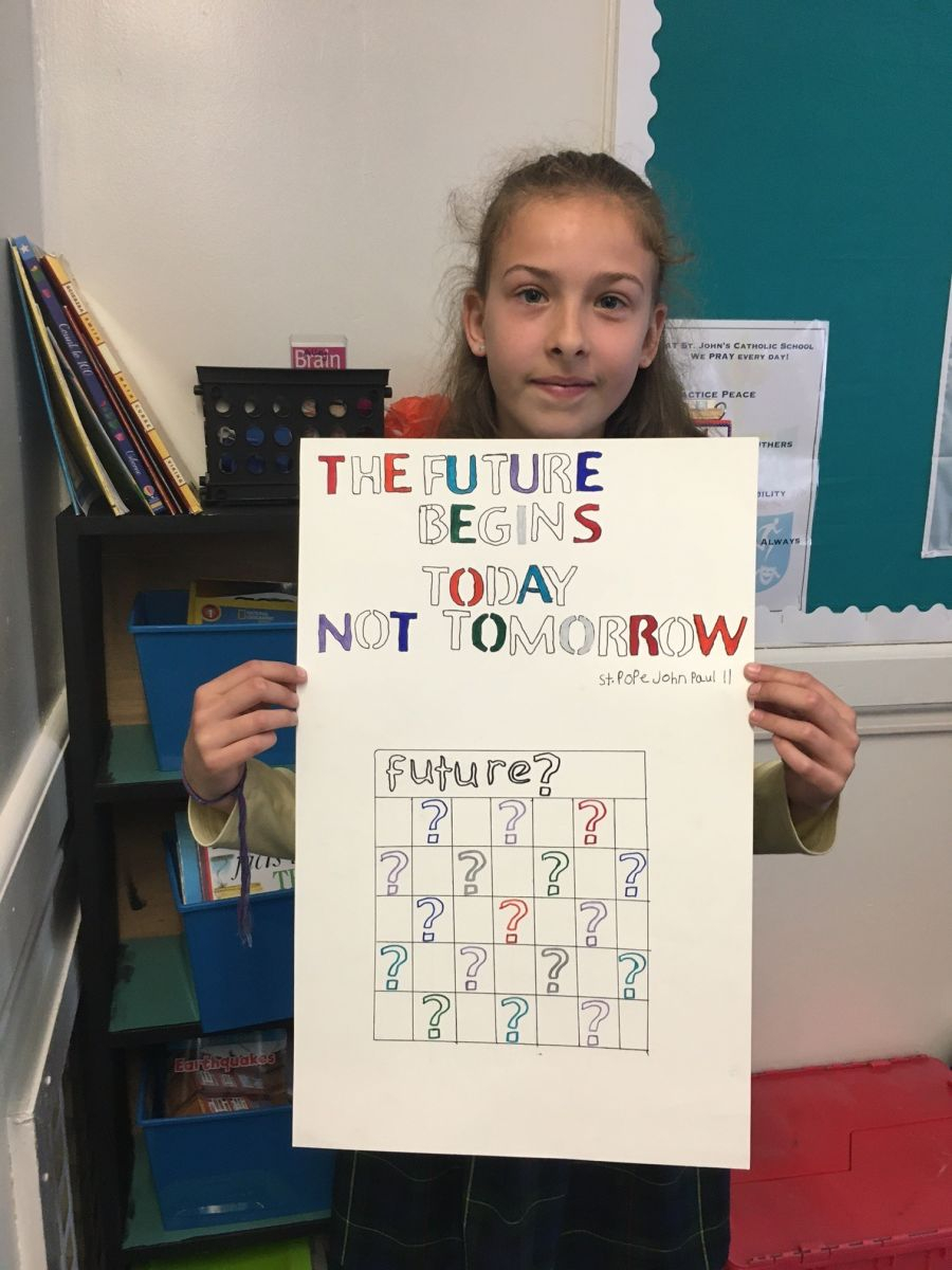 Teen holding up a poster