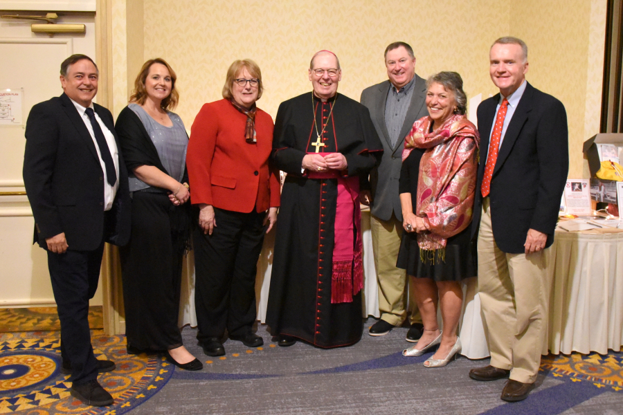 School principals pose with Bishop Robert Deeley.