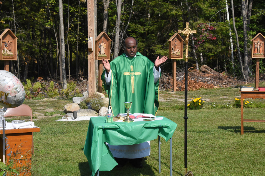 Father Dominic Savio, HGN celebrates Mass outside St. Peter Church in East Millinocket.