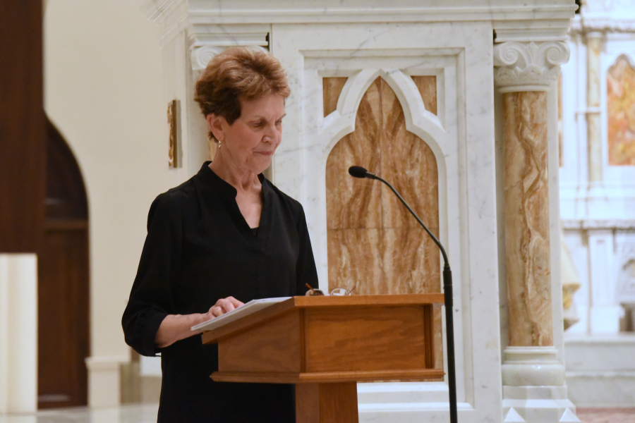 Reading the names of the deceased.