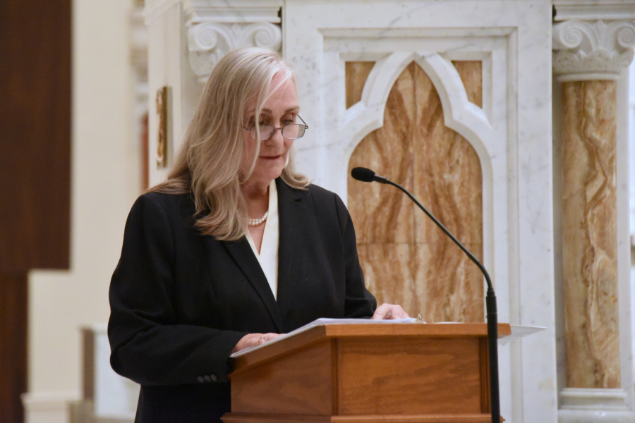 Reading the names of the deceased.