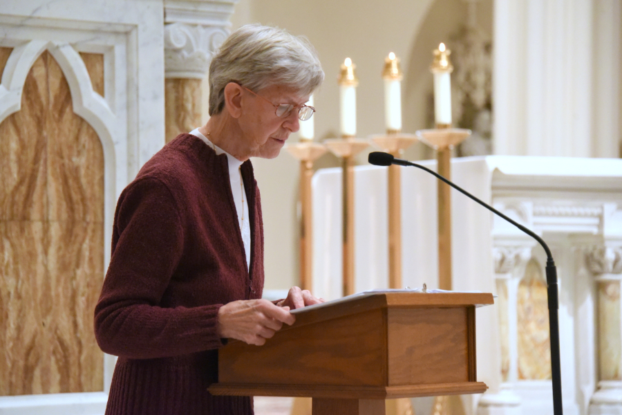 Reading the names of the deceased.