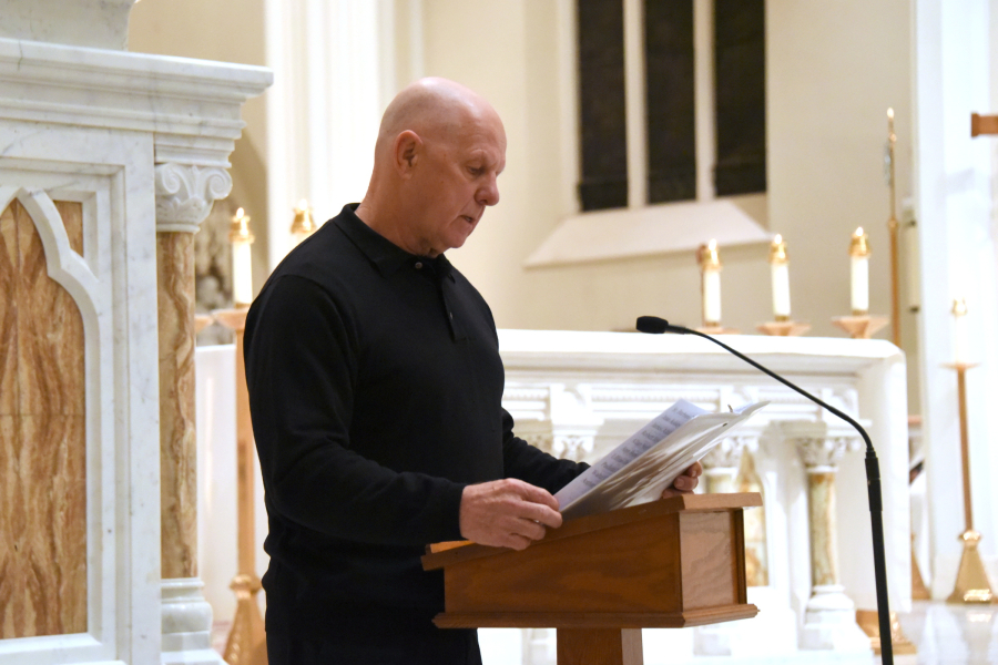 Reading the names of the deceased.