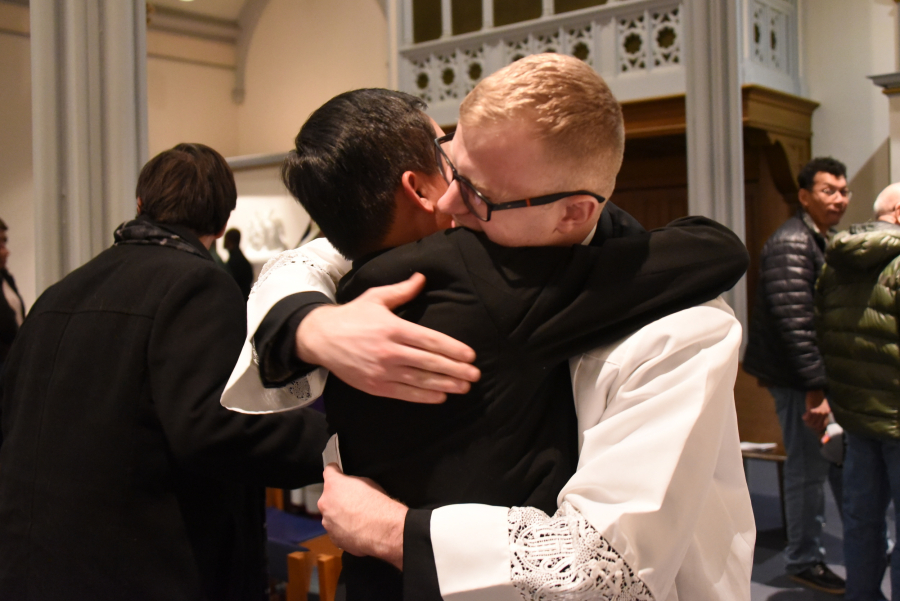 Vinh Nguyen receives a congratulatory hug from Erin Donlan.