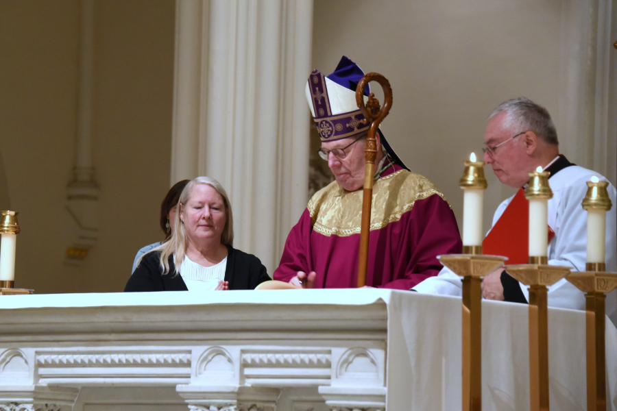 Bishop Robert Deeley signs Book of the Elect