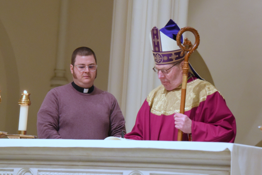 Bishop Robert Deeley signs Book of the Elect