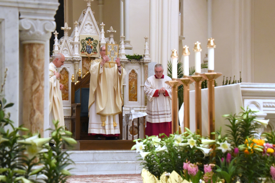 Bishop blessing the congregation with the Book of the Gospels