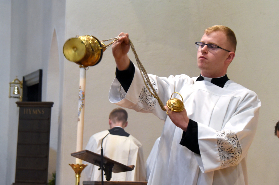 Seminarian Erin Donlan incenses the congregation