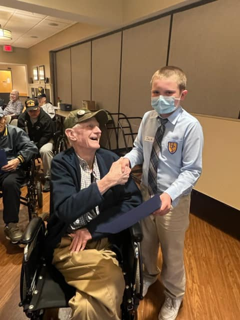 Holy Cross students in South Portland meet their veteran pen pals. 