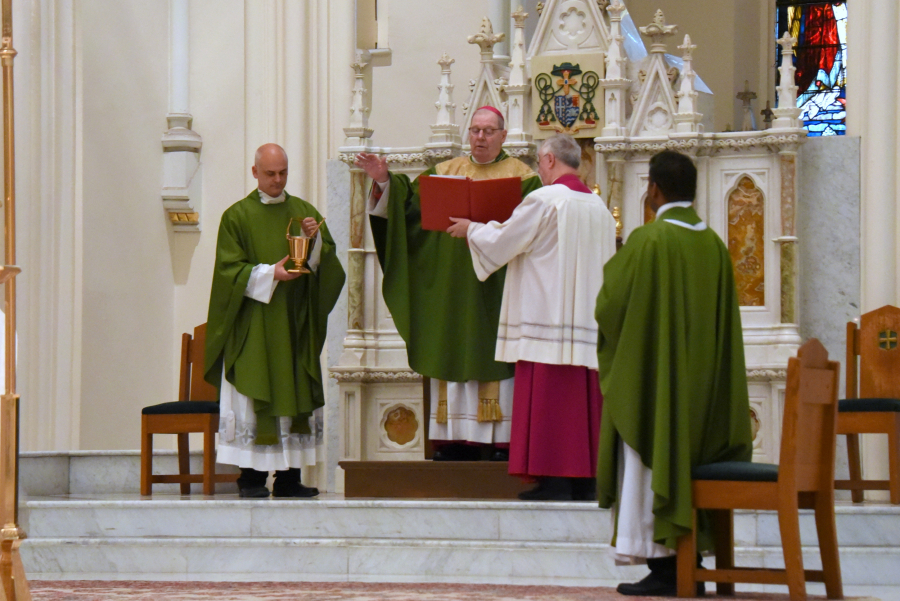 Bishop Deeley blesses holy water.