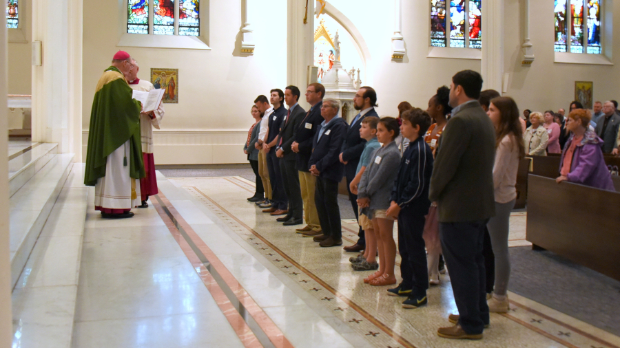 Bishop Deeley blesses the neophytes.