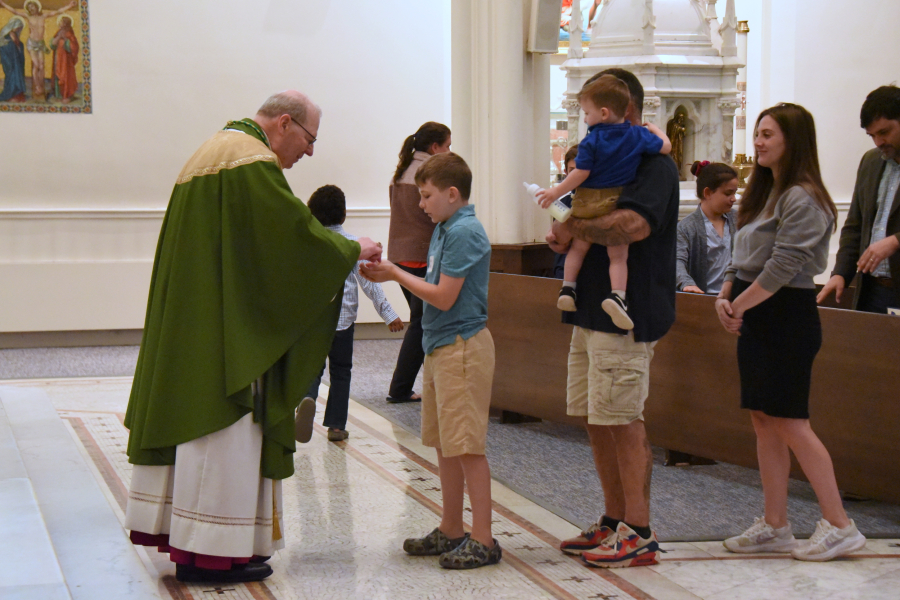 Giving Communion to one of the neophytes