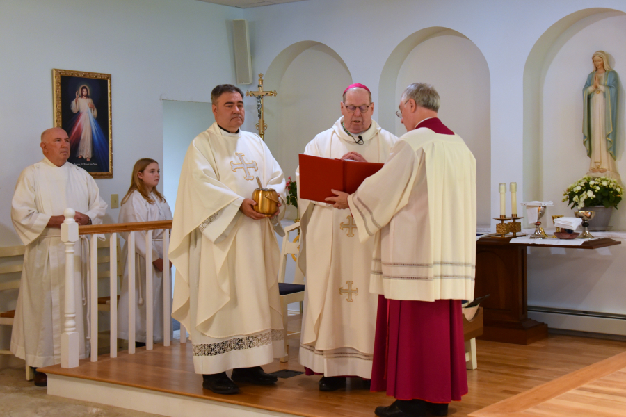 Bishop Deeley blesses holy water.