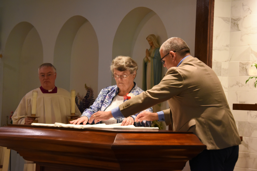 Putting the cloth on the altar.