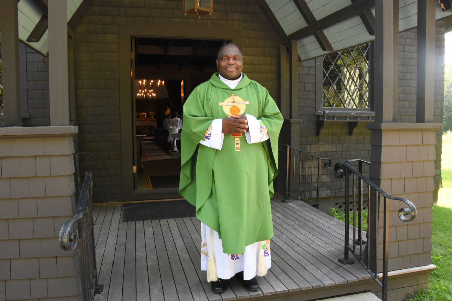 Father Anthansius Wirsiy outside the church