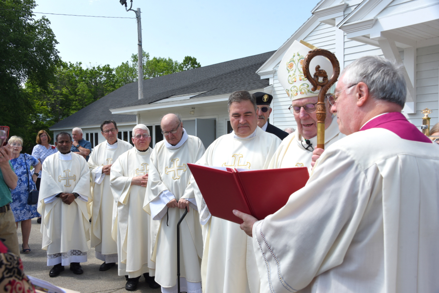 Bishop opening remarks outside the church.