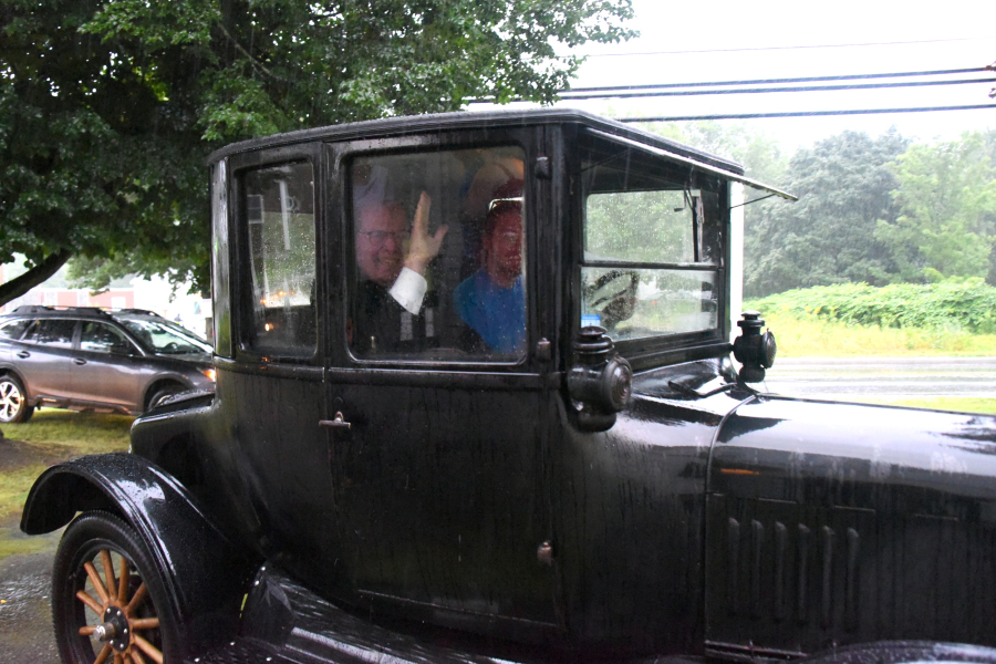 Bishop Robert Deeley rides in a 1923 Model T.