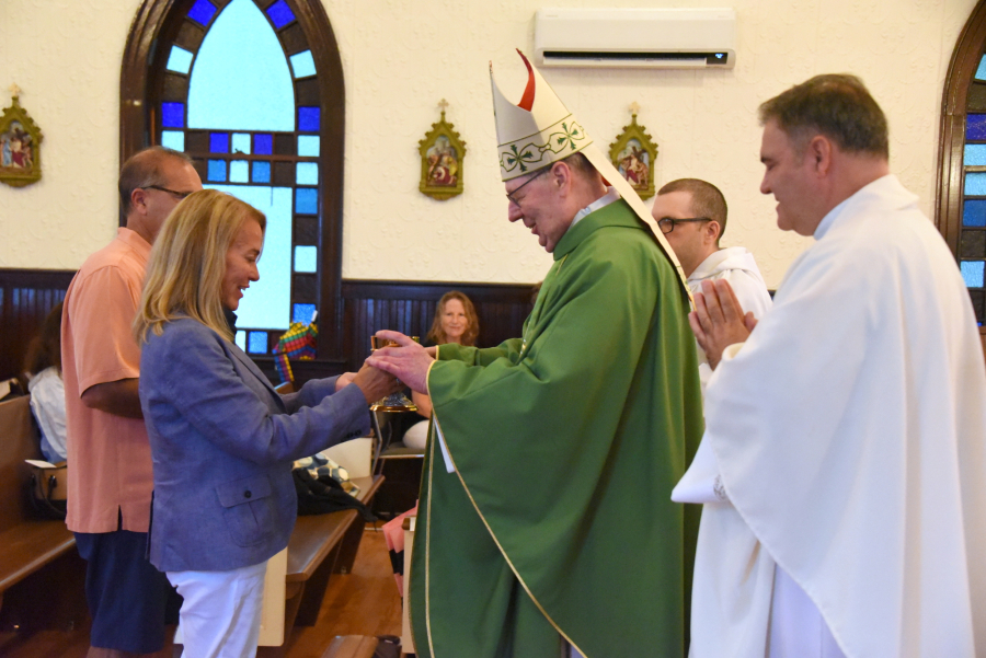 Offertory gifts are presented to the bishop.