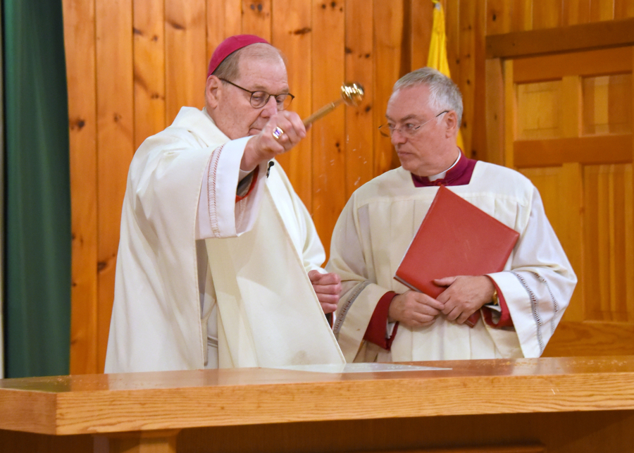 Sprinkling the altar with holy water