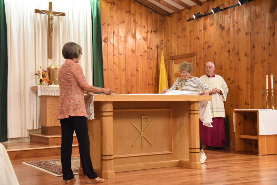 Putting the altar cloth on.