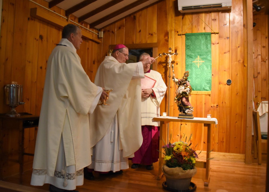 Sprinkling holy water on the statue of St. Gregory