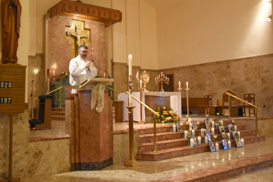 Father Patrick Finn delivers the Gospel reading.