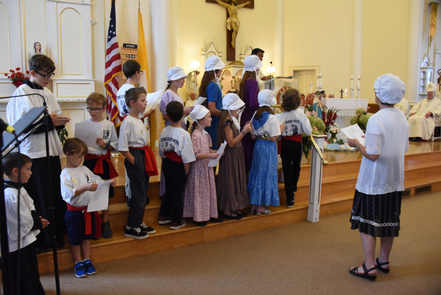 Children sing a French hymn