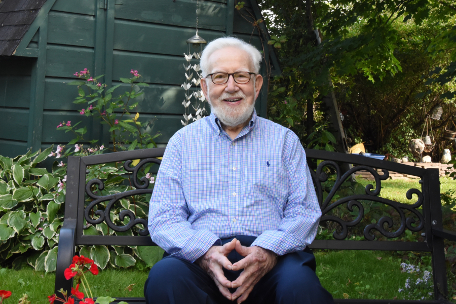 Dan Ladner sitting on a bench in his yard