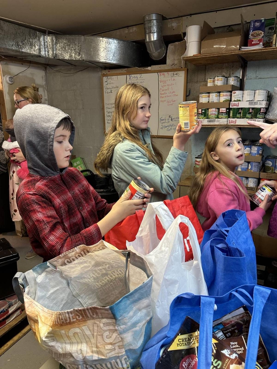Children sort cans of food.